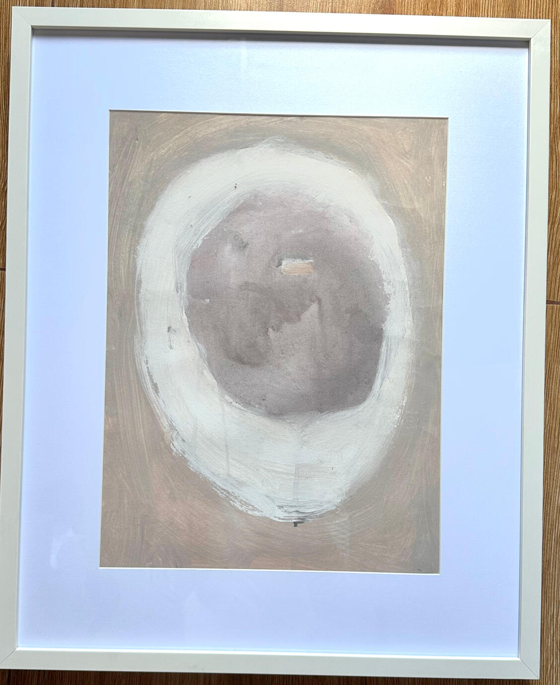 Genesis Veil captures the quiet, suspended moment before life takes form — a soft, rounded shape cocooned within layers of earth-toned washes and translucent whites.